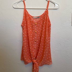 Cute sheer peach colored tank top with white dots and button details. Size XS